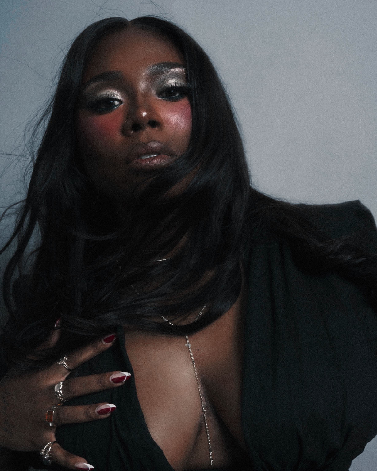 Sierra Von in a black blazer and sculptural silver necklace, photographed by Luke Stage.